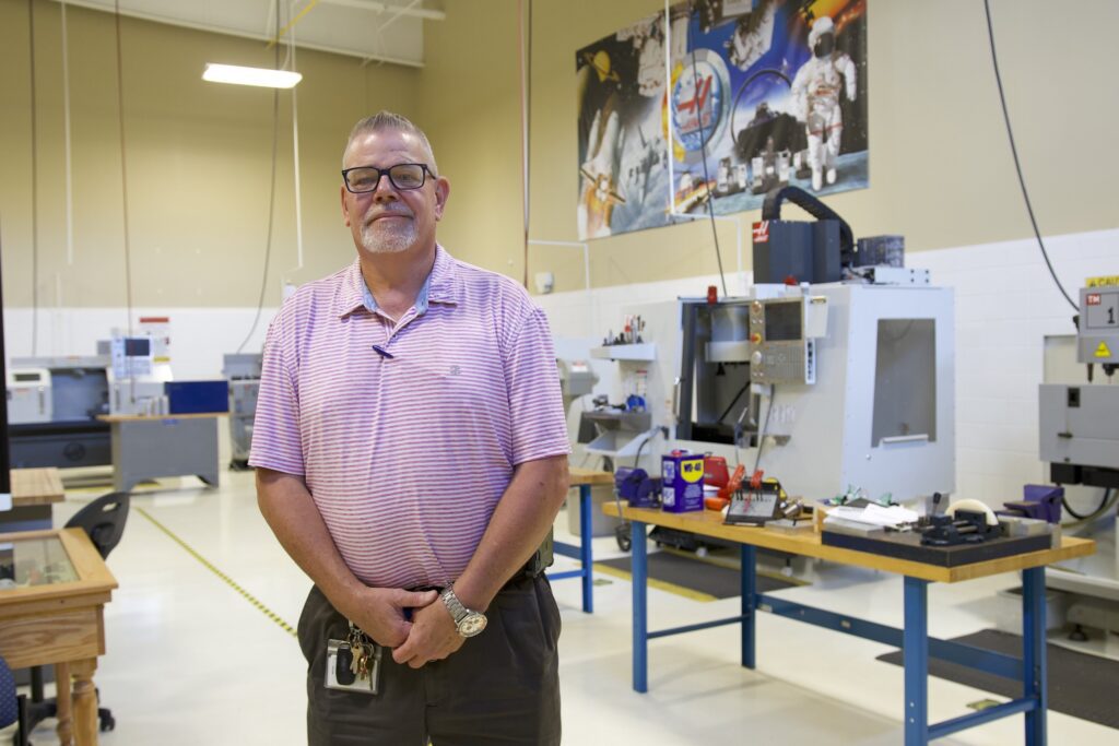 Photo of Billy Spencer in front of an equipment