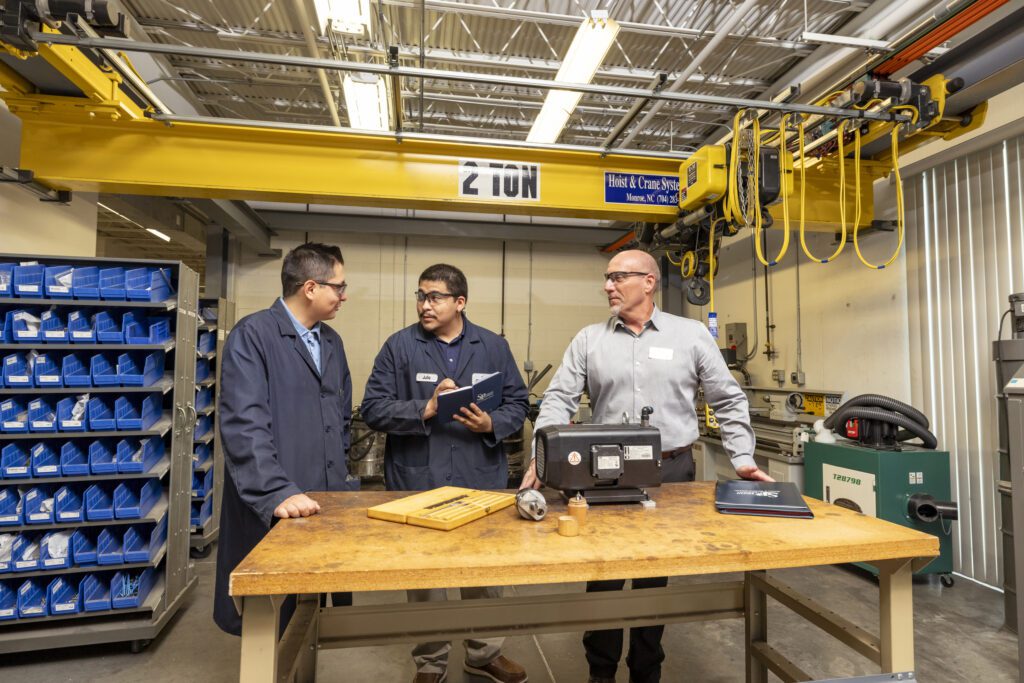 Russell Carpenter overseeing his two apprentices at a facility.