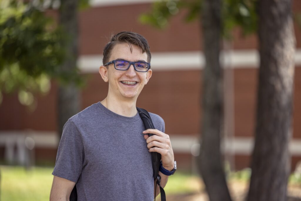 Student with backpack looking at the camera