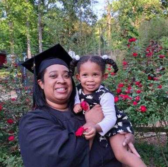 Photo of South Piedmont Medical Office Administration graduate Aanjele Miller holding her daughter, Ajourney.