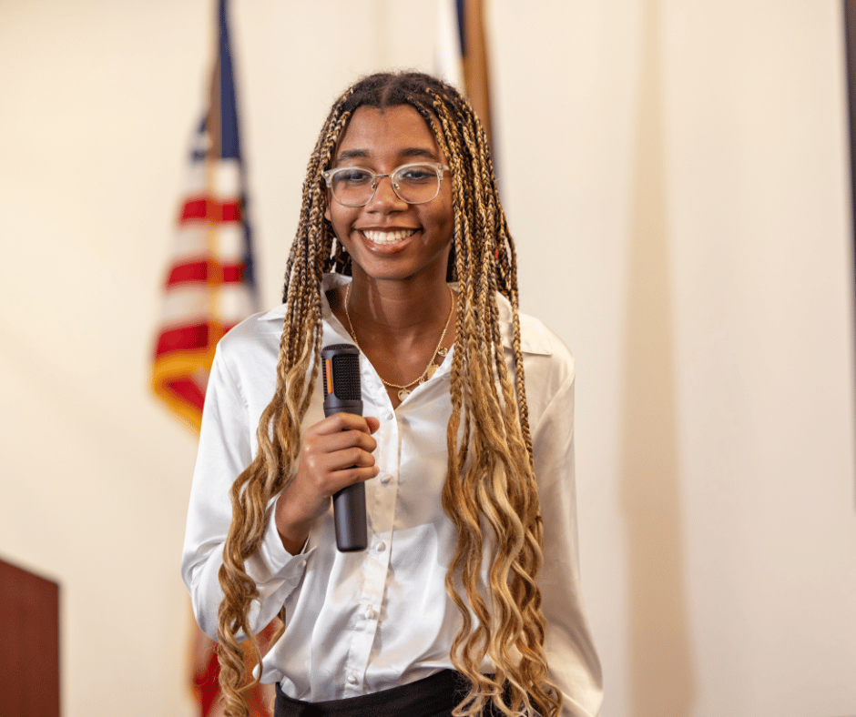Photo of a female South Piedmont student holding a microphone.