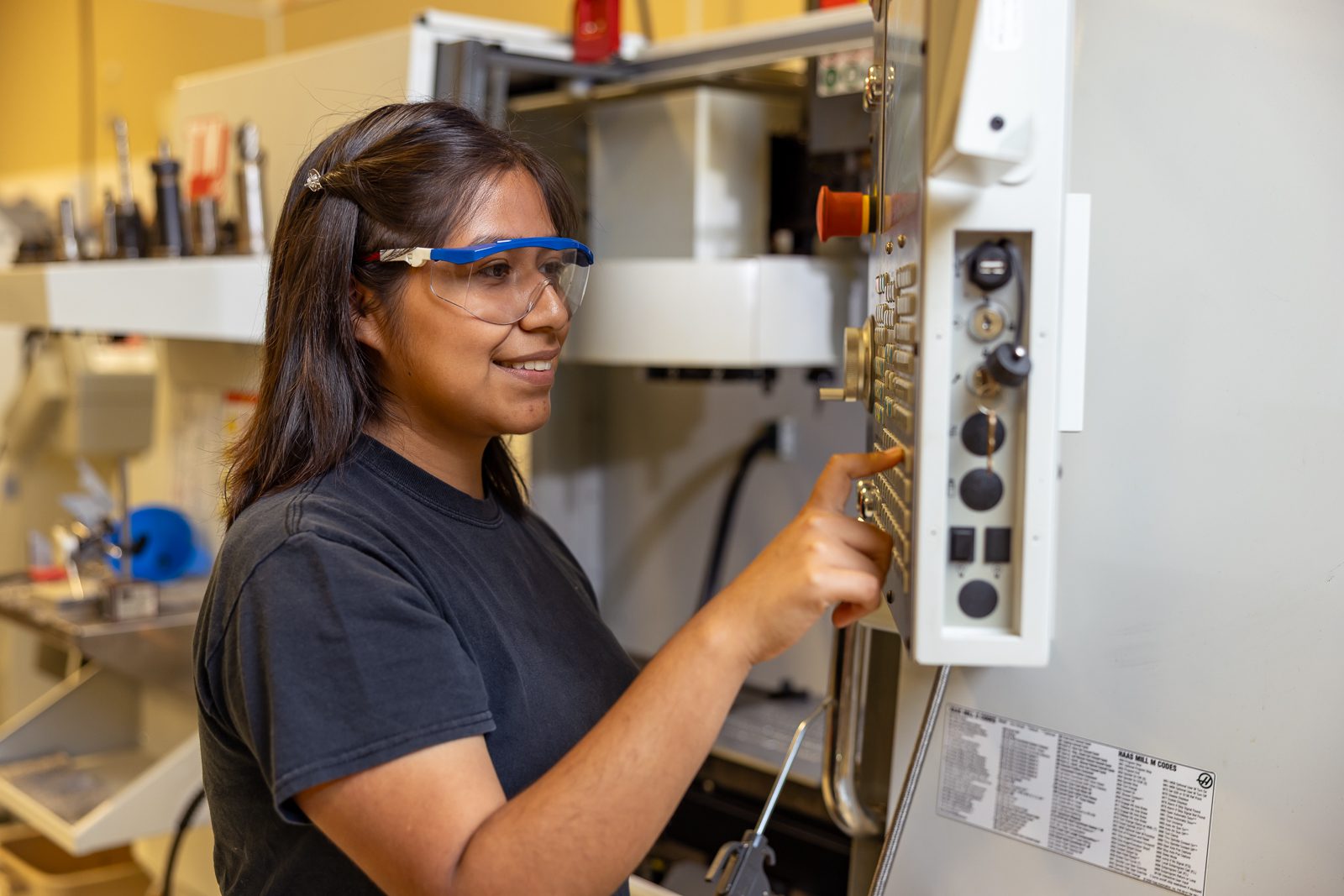 A female student working on an electrical panel.